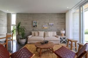 a living room with a couch and a table at Modern 4BR Villa with Private Pool in Paracas in Paracas