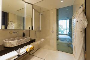 a bathroom with a large sink and a shower at Hotel VIU Milan in Milan