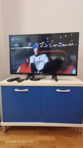 a tv sitting on top of a blue cabinet at Veki's house in Skopje