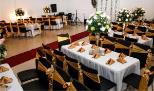 a banquet hall with white tables and chairs at Hotel la Ciudad in Barrancabermeja +19 photos
