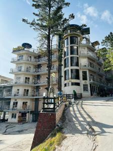 a large building with a tree in front of it at Burj A Zafar in Murree