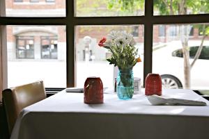a table with a vase of flowers sitting on it at Dude Rancher Lodge in Billings