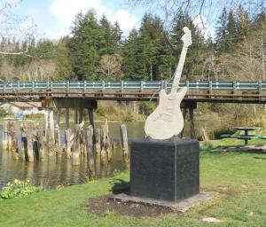 a statue of a guitar in front of a bridge at Travelodge by Wyndham Aberdeen in Aberdeen