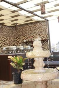 a fountain in the middle of a room at Downtown Hawaa Amman Hotel in Amman