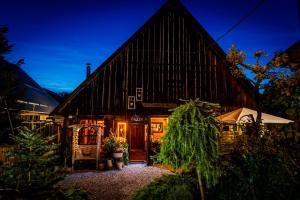 a large wooden building with a large roof at Guesthouse Eden in Liptovský Mikuláš