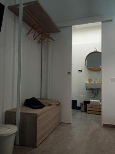 a bedroom with a bed and a sink and a mirror at Maga Mirò - Guest House in Salerno