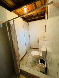 a bathroom with a toilet and a shower at Cabinas Nuestra Kasa in Monteverde Costa Rica