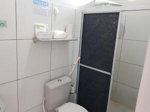 a small bathroom with a toilet and a shower at VilaVerin Apartments in Manaus