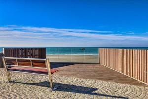 a bench sitting on a beach with the ocean at "Le Petit Marin", 2 ch, parking privé, 8 mn plage in Le Portel