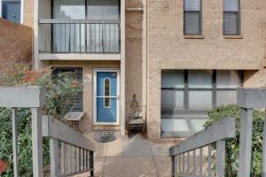 a brick house with a blue door and a balcony at Bethesda Townhome about 10 Mi to DC! in Bethesda