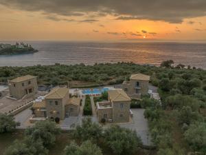 an aerial view of a resort with the ocean at Mythos Villas in Stoupa