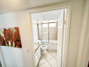 a white bathroom with a toilet and a shower at ৎ୭ Valley Village Privacy Lux ৎ୭ in Los Angeles