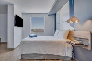 מיטה או מיטות בחדר ב-One Morelia Acueducto