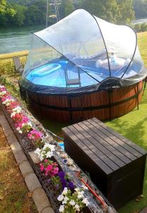 a hot tub with a canopy and a wooden bench at Ferienwohnung am Rhein in Stein
