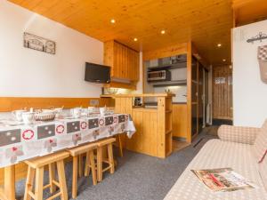 a kitchen with a table and a counter top at Appartement Les Arcs 1800, 2 pièces, 6 personnes - FR-1-346-332 in Arc 1800