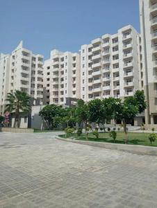 een groot appartementencomplex met bomen ervoor bij Radiant luxury apartment in Agra