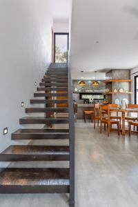 a staircase leading to a dining room and kitchen at Luxury private villa-infinity pool&jungle view in Tulum