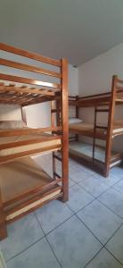 two bunk beds in a room with a tile floor at Pousada Central - Prox da Rodoviaria, Shoping Total, Hosp Santa Casa e Presidente Vargas in Porto Alegre