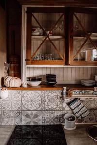 a kitchen with wooden cabinets and a tile counter top at Chata drewniana Stefanówka in Ślemień