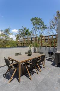 a wooden table and chairs on a patio at Luxury private villa-infinity pool&jungle view in Tulum