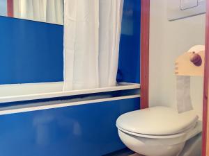 a blue and white bathroom with a toilet and a window at Studio Les Arcs 1800, 2 pièces, 5 personnes - FR-1-346-426 in Arc 1800