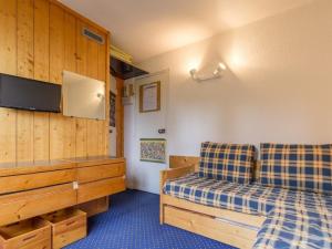 a hotel room with two beds and a tv at Studio Les Arcs 1800, 1 pièce, 2 personnes - FR-1-346-487 in Arc 1800