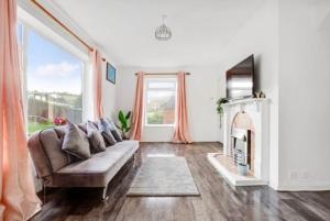 uma sala de estar com um sofá e uma lareira em Sunny 3 Bedroom House in Vibrant Brighton with PARKING & FAST INTERNET em Brighton & Hove