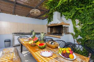 a table with fruits and vegetables on a patio at Villa Sonata in Somatás