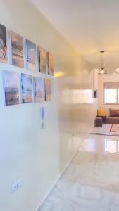 a living room with white walls and white tile floors at Dakhla sky blue in Dakhla