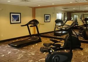a gym with several exercise machines in a room at Comfort Inn & Suites Woodward in Woodward