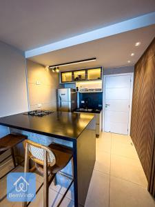 a kitchen with a large island in a room at Apartamento de luxo na Barra com vista mar in Salvador
