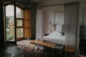 a bedroom with a bed and a large window at Susafa in Vallelunga Pratameno