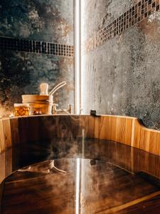 a kitchen with a sink and a counter top at Słone Residence Apartamenty & Beer SPA in Kudowa-Zdrój