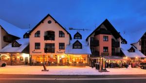 a group of buildings on a street at night at Wellness Pension 7 in Harrachov