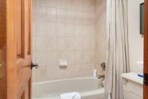 a bathroom with a tub and a toilet and a sink at Lodge at 100 W Beaver Creek Blvd #2 - 401 in Avon