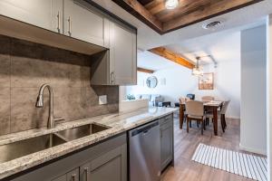 une cuisine avec un évier et une salle à manger dans l'établissement Modern 2 Bed/1 Bath, In-Unit Laundry, Parking + 6 Blocks from Mayo, à Rochester