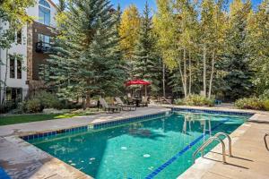 a swimming pool with a table and chairs in a yard at Lodge at Brookside 105 in Edwards