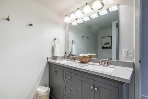 a bathroom with a sink and a mirror at Modern 2 Bed/1 Bath, In-Unit Laundry, Parking + 6 Blocks from Mayo in Rochester +9 photos