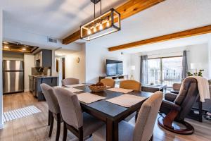 a dining room and living room with a table and chairs at Modern 2 Bed/1 Bath, In-Unit Laundry, Parking + 6 Blocks from Mayo in Rochester