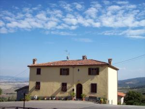 a large white house sitting on the side of a road at Casa Amedeo in Chianni