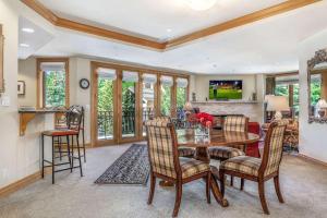 a kitchen and living room with a table and chairs at Beaver Creek Lodge 411 in Beaver Creek