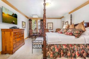 a bedroom with a large bed and a wooden dresser at Beaver Creek Lodge 411 in Beaver Creek