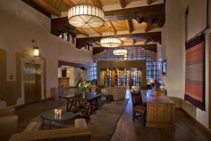 a large room with tables and chairs in a building at Eldorado Hotel and Spa in Santa Fe
