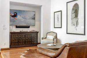 a living room with a couch and a tv at Quartermoon 1248 in Beaver Creek