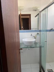 a bathroom with a sink and a mirror at Shopping Campos Boulevard in Campos dos Goytacazes