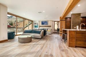 a large living room with a couch and a kitchen at Beaver Creek Lodge 510 in Beaver Creek