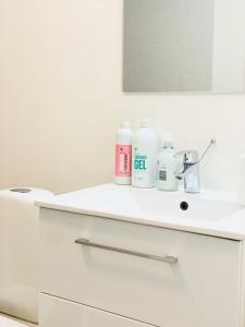 a white bathroom with a sink and a mirror at Scandinavian House Hotel-Lunden- Central 3 bedroom house in Horsens