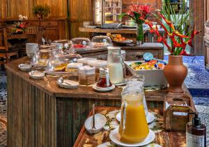a table with food and drinks on it at Grajagan Surf Resort in Ilha do Mel