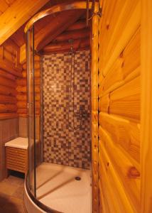 a bathroom with a shower in a wooden cabin at Paradise Chalet in Ano Trikala