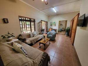 a living room with a couch and a table at Home on a Hill Accommodation in Tzaneen